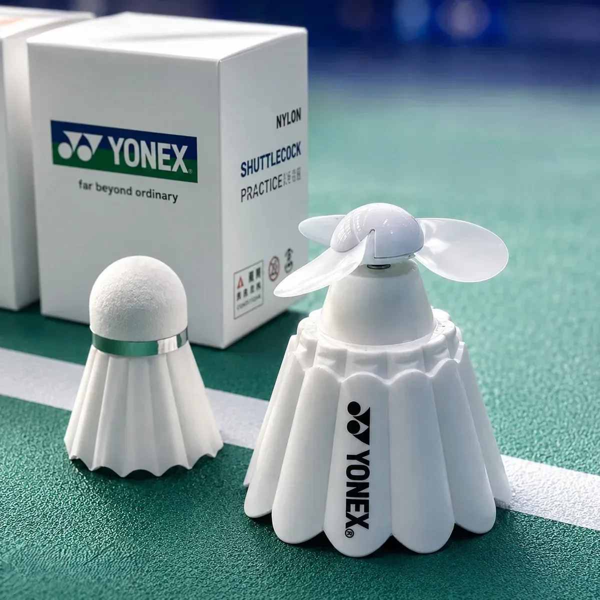 Yonex branded portable mini fan shaped like a badminton shuttlecock. - FN1
